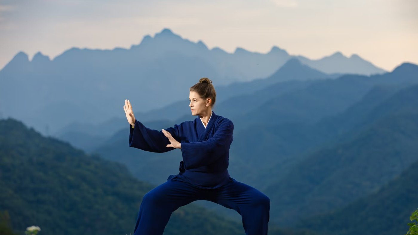 Practicing Tai Chi against misty Sichuan mountains