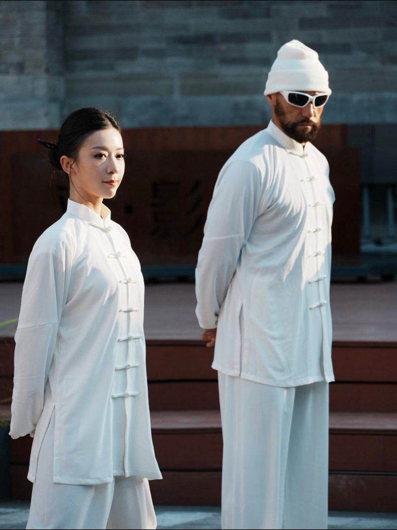 Practicing Tai Chi in traditional white dress