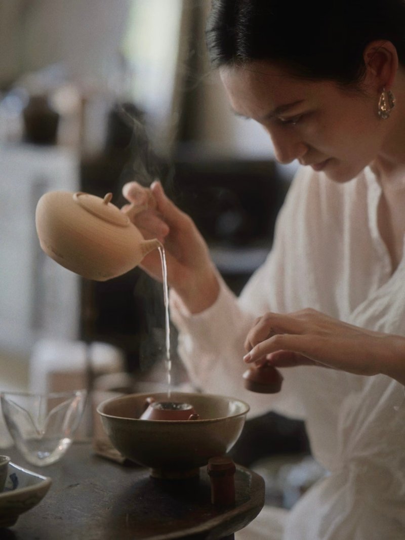 Warming the teapot with hot water
